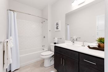 Bathrooms finished with tile flooring and tub surrounds